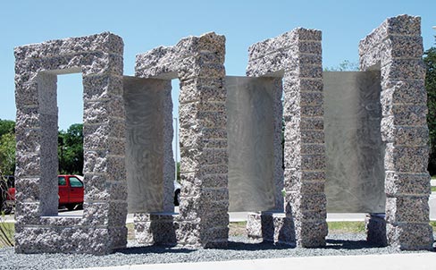 According to Jon, “Fenestrae Aeternitatis: White Rock” at the White Rock Hills Public Library, Dallas, Texas is one of his favorites and was made by first splitting the four blocks of Texas Pink Granite, and then letting the factory cut the holes with a wire saw. “I carved the 4 blocks to look like large books and the stainless steel connecting ‘pages’ imply that one book opens to the next book,” said Jon, noting that it was very hard stone.