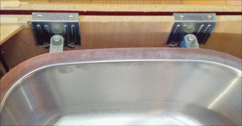 Top and under sink views of  installed Super Fast Sink Brackets. One of the advantages this system offers is ease of installation, the strength and stability provided by  the carbon steel spring clip and the bolts and hardware made of grade 8, high-strength steel. 