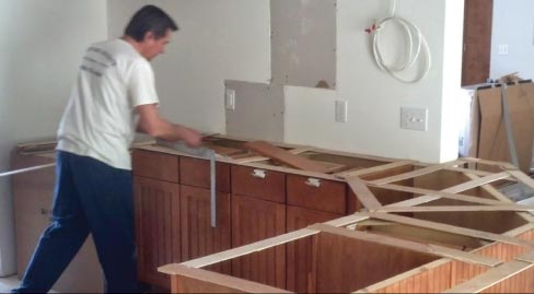 August prepares a stick countertop template at a residential construction jobsite.