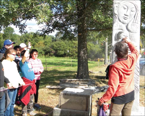 One of the requirements for participating artists was to educate the audience. Shown is Artist, Miss Lise Becu fulfilling that obligation to the many school children that attended. Lise, like many U.S. artists, was a past participant in the Schoodic International Sculpture Symposiums held exclusively in Maine over the last ten years. 