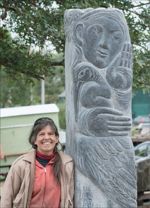 Artist Lise Becu, a Schoodic International Sculpture Symposium veteran, is shown with her latest sculpture. All stone was supplied by J.C. Stone of Jefferson, Maine.