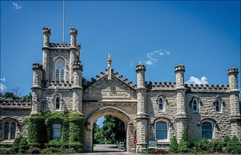 Entrance gate to the Rosehill Cemetery, Chicago, designed by W.W. Boyington. The Gothic Revival crenelated walls and towers were built with Joliet limestone about 5 years before the Chicago Water Tower, c.1864.  Rosehill is the largest cemetery in Chicago, with memorials to the Union and Confederate soldiers buried there. It contains the largest number of Union soldiers buried in any private cemetery in the U.S.