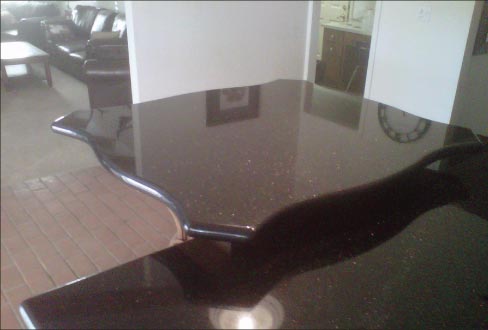 This complex Black galaxy countertop shape was created using a hand router – and considerable skill.