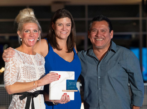 Jessica McNaughton accepts the Associate of the Year Award for Caragreen, with ISFA Executive Director Amy Miller (left) and ISFA President Augie Chavez (right). 