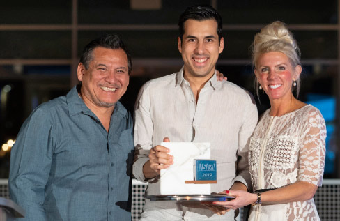 Rodrigo Velazquez receives the Innovator of the Year Award, with ISFA President Augie Chavez (left) and ISFA Executive Director Amy Miller (right). 