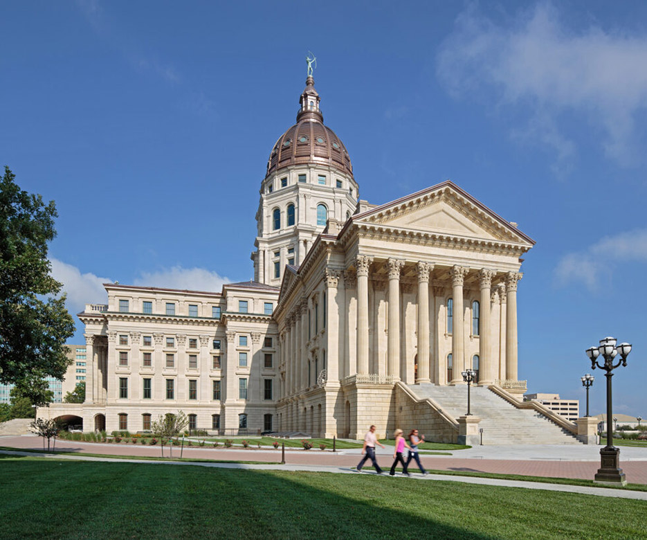 The Kansas Statehouse exterior masonry restoration, completed in 2011, required over 7,000 dutchman repairs varying in size from a few pounds to several thousand. The façade features four types of limestone and seven granite, dating from the original construction to subsequent repairs. The project received a 2018 Tucker Design Award.