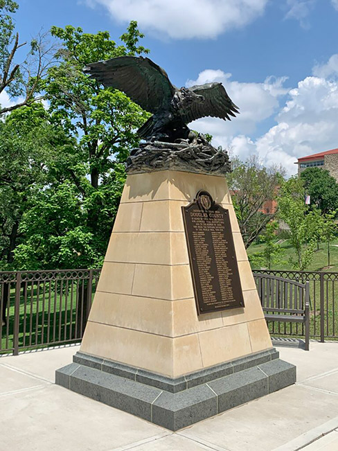 The 1929 bronze sculpture, Victory Eagle, moved to a new home along Memorial Drive at the University of Kansas in 2019. The stone pedestal follows the pattern historically recommended by the Victory Highway Association, which organized the memorials in 1921 to commemorate the loss of life in World War 1. Silverdale limestone, quarried in southern Kansas, and Mountain Green granite from Coldspring form the pedestal. Photo credit Julia Mathias Manglitz.