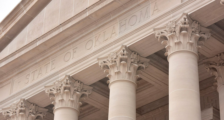  Oklahoma State Building: From 2016 to 2020, Manglitz was the project manager for exterior masonry repairs to the 1917 Oklahoma State Capitol. The restoration included replacing veneer panels, dutchman repairs, crack pinning and injection, cleaning, and repointing. Tishomingo pink granite from Oklahoma clads the first floor, and Hoosier silver-gray from Indiana Quarries clads the upper floors. Photo credit F. Stop Photography/TreanorHL.