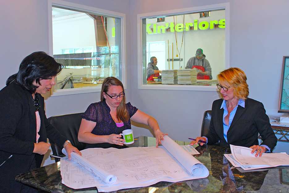 Grandlienard, pictured at left, meets with design staff in the ROCKin’teriors design space.