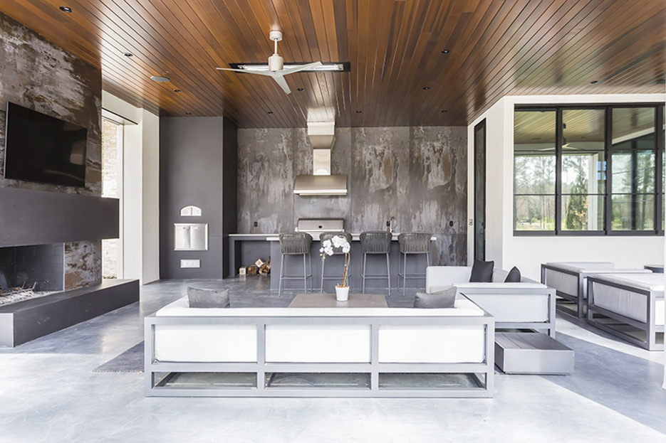 This outdoor kitchen in Raleigh, N.C. features wall cladding in Dekton Trillium, an Italian pizza oven surrounded by Dekton Domoos, and counter surfaces in Caesartone Raw concrete.