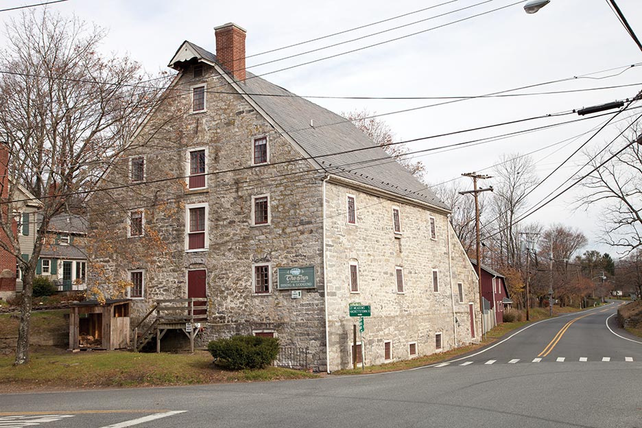 Designed by Christian Christianson (the designer of the Bethlehem Pennsylvania waterworks) and constructed in 1770 by master mason Philip Maixel and carpenter Joseph Grotz, the grist mill was the first of many structures to be made from locally quarried rough-cut limestone. This renovated structure was made into a bed and breakfast in 1986 and is currently The Inn at Millrace Pond. Records show that the mill provided flour to General George Washington’s Continental army, while based at nearby Jockey Hollow, New Jersey.