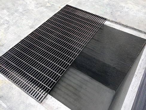 Samples of completed 6 ft. x 6 ft. x 7-1/2 ft. deep collection pits, with heavy-duty grates, rated for vehicle traffic.