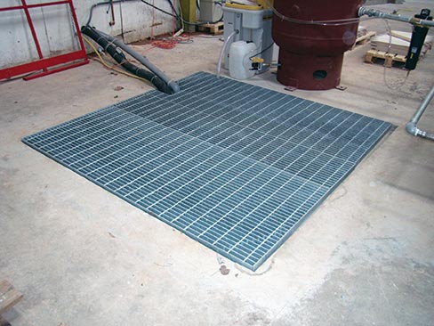 Samples of completed 6 ft. x 6 ft. x 7-1/2 ft. deep collection pits, with heavy-duty grates, rated for vehicle traffic.