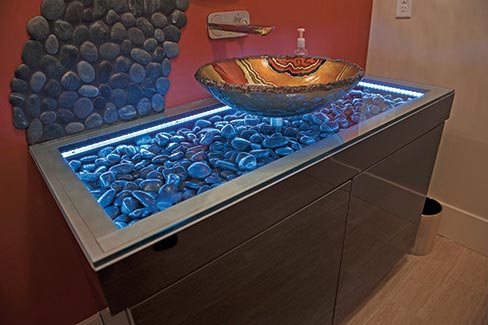 Hidden Creek, a small custom cabinet shop located in Ohio, supplied this unique black acrylic vanity. The onyx vessel sink was the client’s choice, from an unknown source.