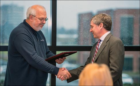 Herb Miller presenting award to Michael Franceschelli. Miller congratulated Florida Tile on its 60th anniversary and said the company has done well to focus both on business and supporting communities. 