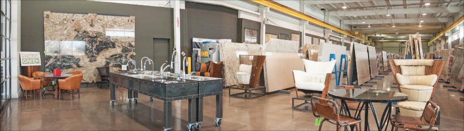 The 11,000 square foot DMG slab gallery includes a rolling sink display, and a large selection of stone presented as full slabs and large, wall-mounted samples.