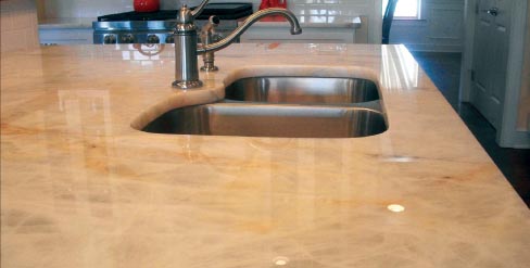 This Quartzite island with undermount sink typifies DMG work: truly gorgeous and dramatic stone installed with care and the highest professional execution.