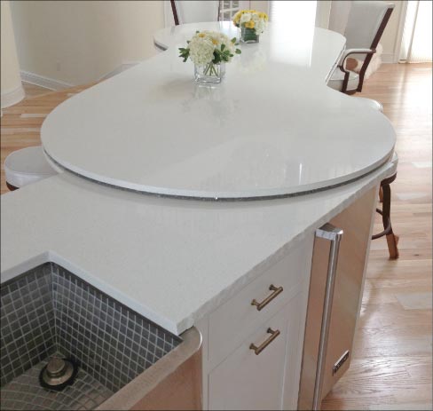 The chiseled edge sink surround island, smoothly built into the bottom layer of the dining peninsula, was produced with a Stone Pro Beaver – after test chiseling a sample, to see if it would work.