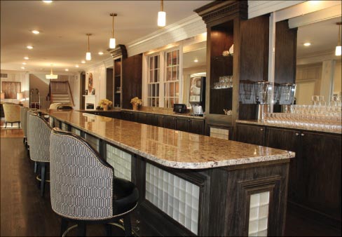 Emco-Williams installed New Venetian Gold granite tops in common areas, of the Alexander Guest House, like this bar in the former lobby, reception desks, and the patron dining area.