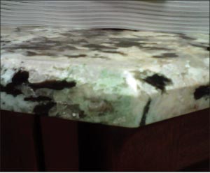 A typical blue-green stain caused by cyanoacrylate glue. CA stains occur as a reaction with the minerals in certain types of granite.