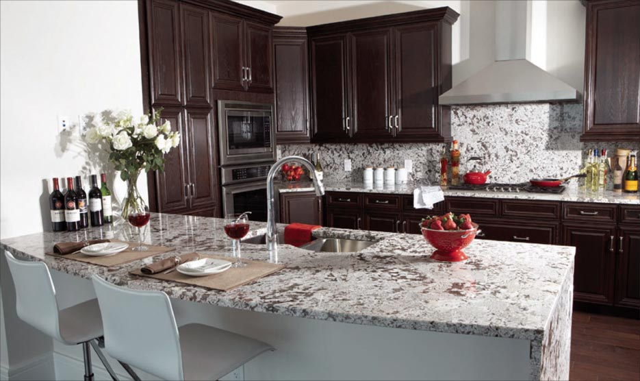 Bianco Antiquo granite island and counter in this Peachtree Street condo features a subtle curved edge with a mitered  side panel.