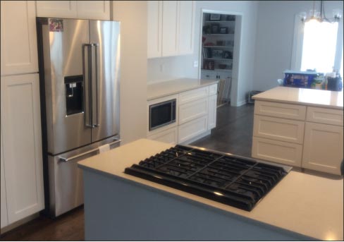 Quartz countertops and islands, with custom cabinetry for a residential kitchen.