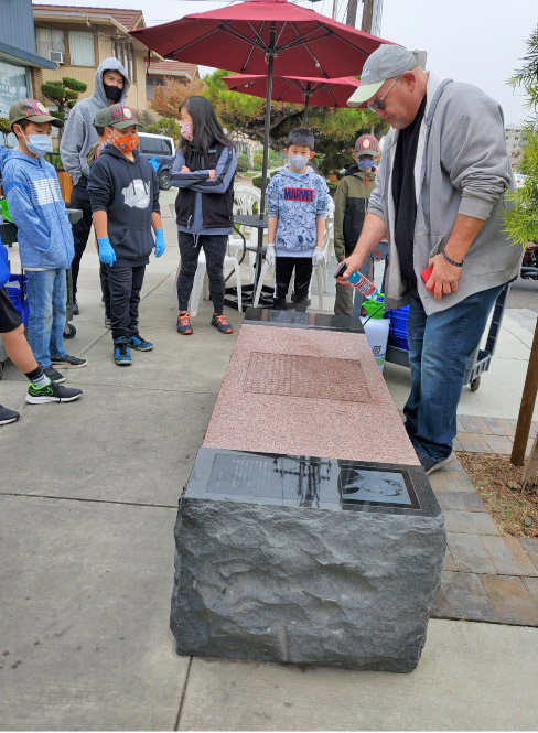 Bonasera demonstrates cleaning to his Cub Scout volunteers.