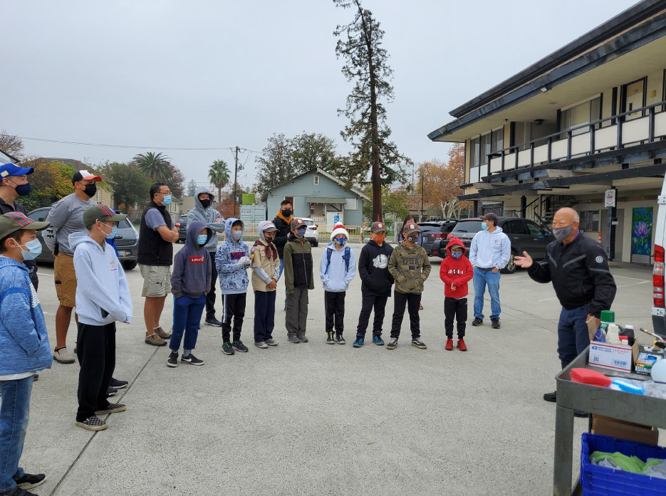  A retired police officer goes over safety protocols before the volunteer crews spread out to their assigned restoration projects.