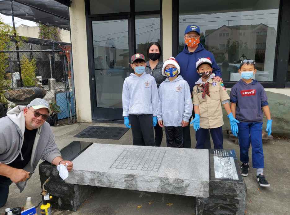 Bonasera demonstrates the cleaning process to the Scouts, and explains the types of stone they are working on, before removing some graffiti