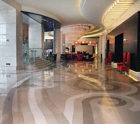 For this 2010 hotel in Shanghai’s upscale Putuo district, VOA Associates designed a contemporary interior that incorporated a unique wind-pattern theme with a Tornado Bar and a swirling ceiling fixture. The custom floor design was to follow the curving lines of the ceiling fixture—not only to further the wind-motion theme—but to direct the flow of traffic from the hotel’s lobby to the reception desk and from there to guest rooms and into the bar and seating areas