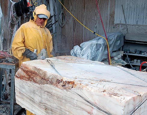 Donning full wet gear, Eino wet cuts the base for “Quantum Movement” as the vertical section awaits treatment in the background. 