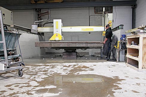 Eight-year employee Shane Valle operates one of two GMM bridge saws in the company’s line-up of equipment.