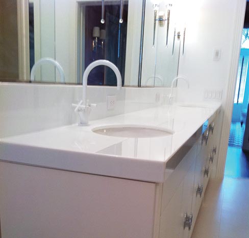 This large Glassos® Nano White double vanity with inch and a half mitered laminated edges graces a New York City brownstone home. Glassos® Crystal White comes in 73 inch by 120 inch in 2cm, and 57 inch by 120 inch in 3cm. Glassos® Nano White comes in 56 inch by 120 in both 2 and 3cm slabs. Most of CCS Stone’s 40,000 square foot warehouse is serviced by three 3-axis cranes. 