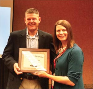 Jack Millea, Regional Manager at Realstone Systems, accepts the Educator of the Year award from Sarah Gregg, CEU Administrator at MIA+BSI, at the TISE 2016 CEU Speaker’s Breakfast.