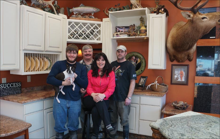 From left to right: Harrison Hoffmeyer holding Penelope Squirrel (their Boston Terrier mascot), Matt Hoffmeyer, Julie Hoffmeyer and Terry Hoffmeyer. 