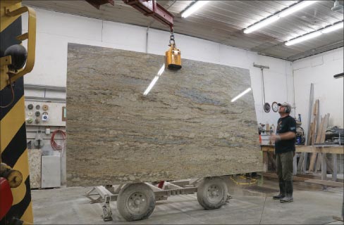 Terry Hoffmeyer loads a 3cm slab onto their concrete tilt bench. “Customers are encouraged to either view selected slabs at one of four vendors or be here when they’re delivered. If they don’t like them they are sent back,” said Julie Hoffmeyer.