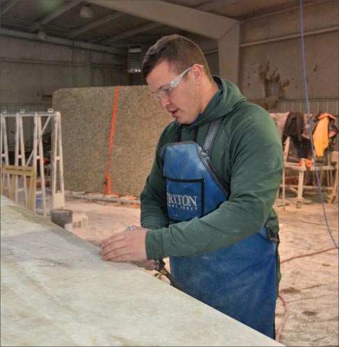 Clark applies a hand-finished touch to a custom-length countertop.