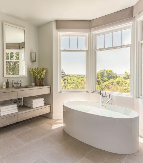 Custom kitchen and bath for residential customer features Tao Grey brushed limestone counters and large format floor tiles in the master bath. 