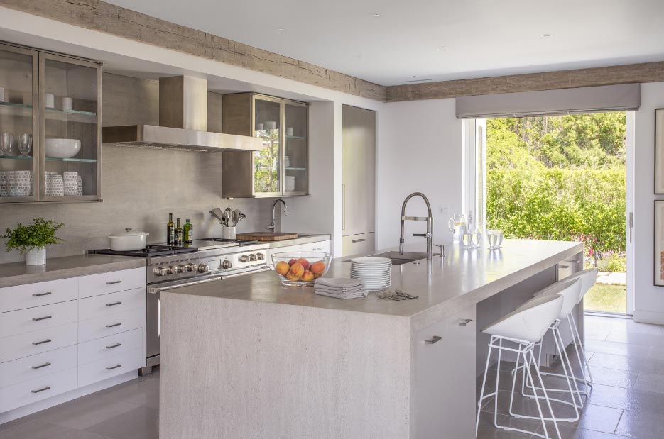 Custom kitchen and bath for residential customer features Tao Grey brushed limestone counters and large format floor tiles in the master bath. 