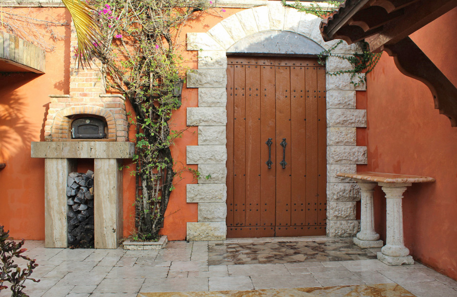 An architectural sampler of dimensional stonework and paving includes a wood-fired pizza oven.