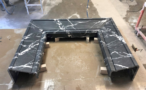 Black Moon marble fireplace surround fabricated by the Fox Marble Custom division, which excels in fabricating large, 3-D projects