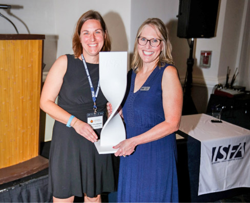 Kate Dillenburg, Bisley Fabrication, accepts the 2022 ISFA Hall of Fame Award with Nancy Busch, ISFA Executive Director, at the 2022 ISFA Annual Conference in Clearwater, Florida.