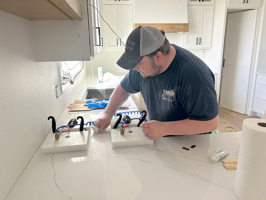 Jeff Heiar works on setting up a seam in this residential kitchen remodel. All his fabricators are cross-trained to fill in as needed. Jeff will often help with installations, and Hannah works directly with clients.