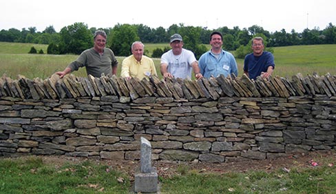 Neil Rippingale led a team of masons rebuilding fences at a Hebron Cemetery workshop in 2011. Inset and above: DSC stone dressing workshops teach the basics of trimming, chiseling and dimensioning stone to suit, for a perfect fit.