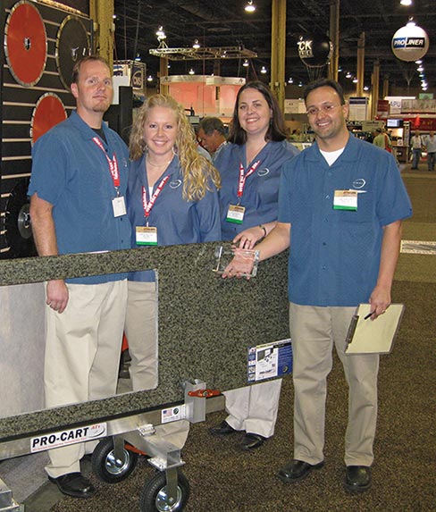 Omni Cubed founders accept a trade show award for the Pro-Cart AT1 at StonExpo 2008. At StonExpo 2013, two more awards were presented for their next-generation Pro-Cart AT2 model.  From left: Derek Westlund, President and Director of Production; Kirsten Westlund, Director of Finance; Amy Livingston, Director of Sales and Marketing; and Larry Livingston, Vice-President and Director of Engineering. 