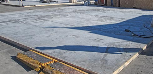 The WerkMaster™ crew unpacks by the expanse of new concrete waiting to test their machines.