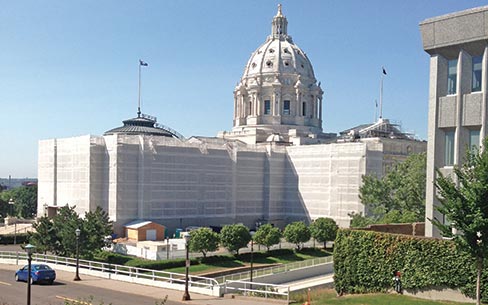 After 2 months and 14 semi-trailer loads of  scaffolding, full-coverage safety netting cocoons the building. The netting helps with debris and dust control.