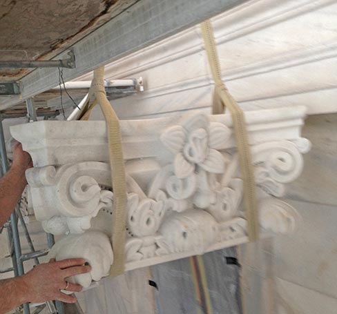 Installing a 1,000 lb. carved Dutchman repair to a Corinthian capital. “I don’t think there is a stone or existing profile that won’t be replaced or repaired, with some areas having more stone replaced than others,” says Scott Evett of Mark 1 Restoration.