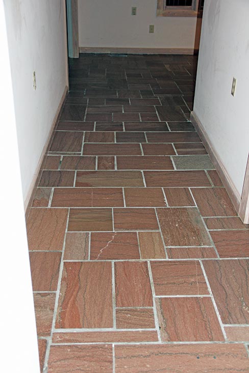 The same hallway after the grinding and honing process. This floor was left honed then color enhanced as polishing was problematic due to the sanded grout.