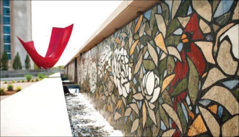 Flower pattern terrazzo waterwall at the J.W. Marriott plaza in downtown Indianapolis, fabricated from natural stone slab pieces. Cut on Santarossa’s water jet machine,  the pieces were mounted into a black, cement-based terrazzo, the design installed on site by their craftsmen.